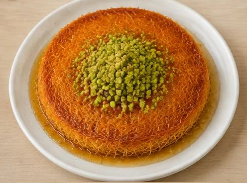 Künefe dessert of shredded pastry and cheese on a wooden board