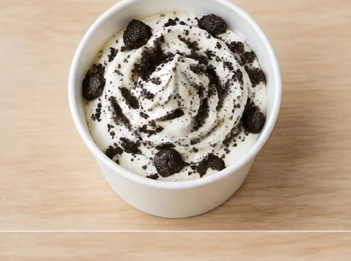 Oreo McFlurry with crushed cookie pieces in a cup on a wooden table