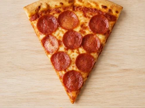 Pepperoni pizza slice with melted cheese on a wooden board