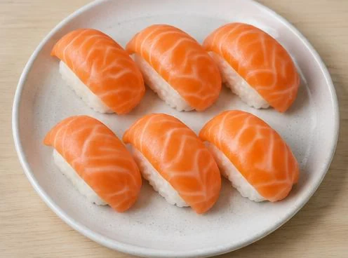 Six pieces of salmon sushi on a wooden board