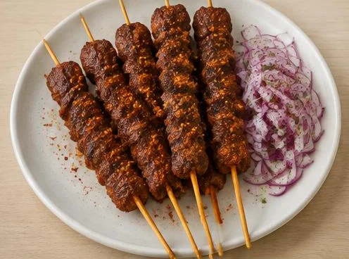 Suya spiced grilled meat skewer on a wooden board